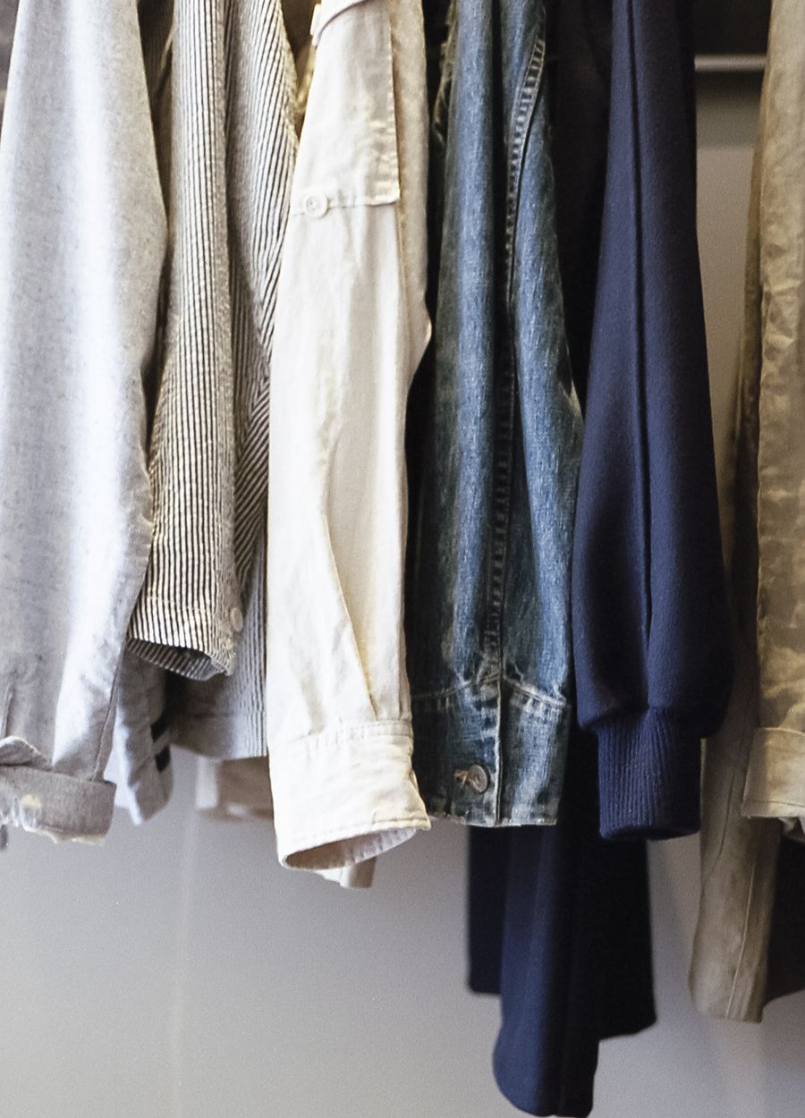 Freshly cleaned shirts and jackets hanging on a rail